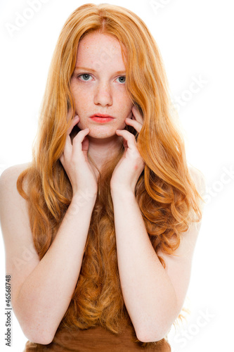 Pretty girl with long red hair. Fashion beauty studio shot.