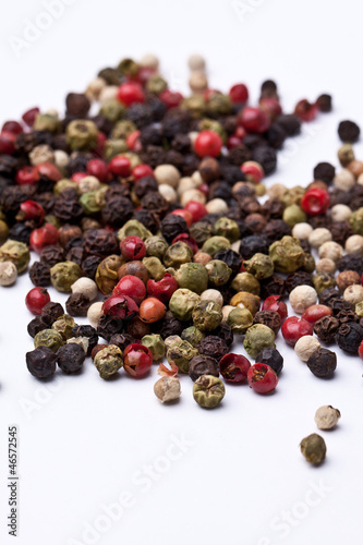 colored grains of pepper, close-up on a white background