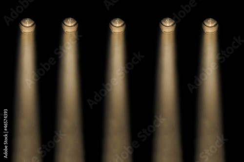 Five yellow spotlights in a smoky atmosphere