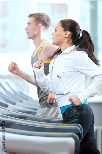 Woman and man at the gym exercising