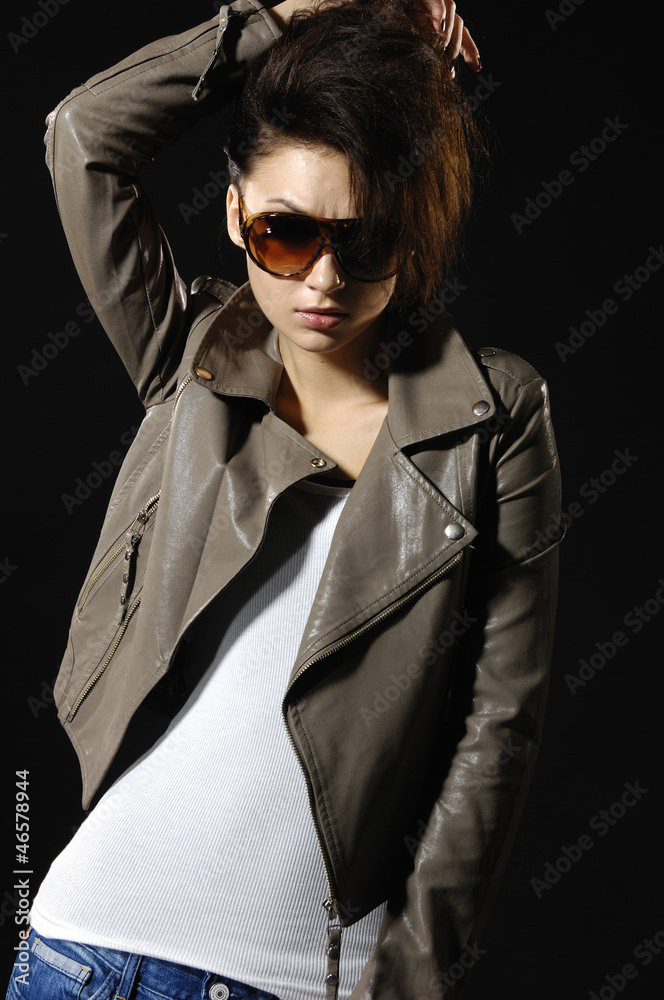 fashion model wearing sunglasses in blue jeans posing fashion model wearing sunglasses in blue jeans posing