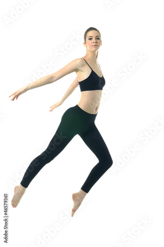 Cute elegant girl in black sportwear jumping