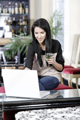 Woman on laptop in wine bar Free Download Woman on laptop in wine bar - GFXLoad