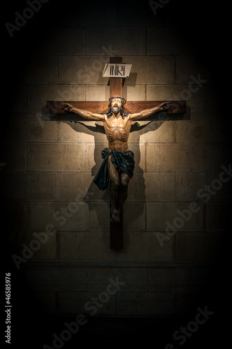 Fotografia, Obraz Crucifix in church on the stone wall.