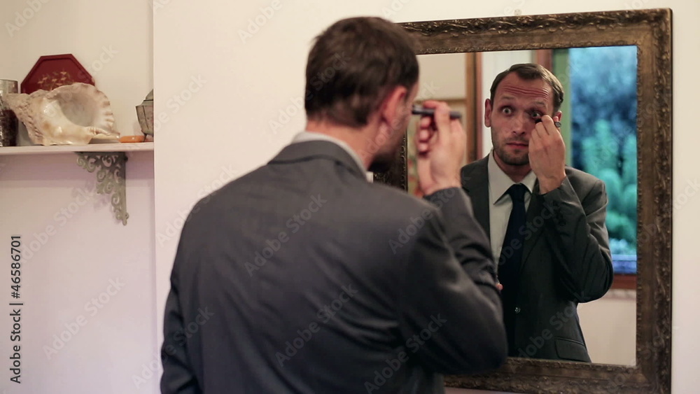 Businessman applying eye cream in front of mirror Businessman applying eye cream in front of mirror
