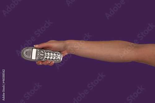 Female hand pointing a remote control