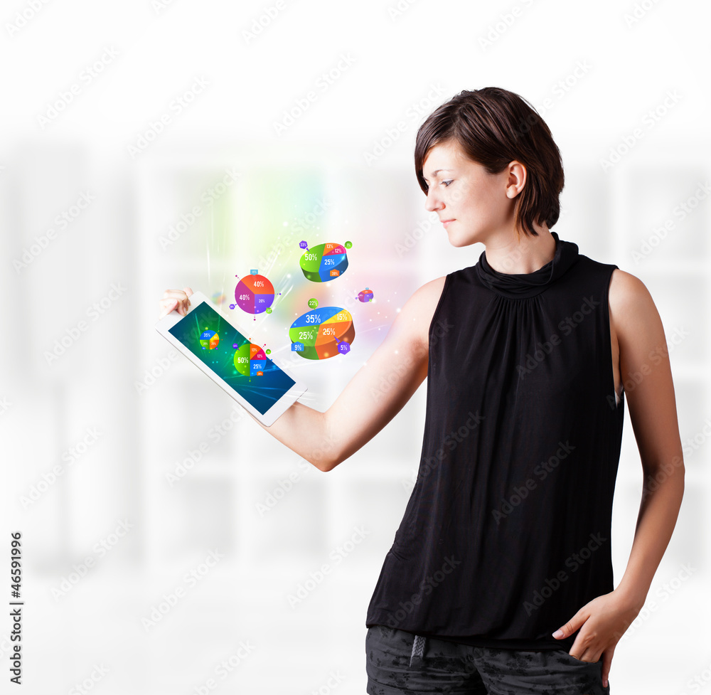 Young woman looking at modern tablet with pie charts Young woman looking at modern tablet with pie charts
