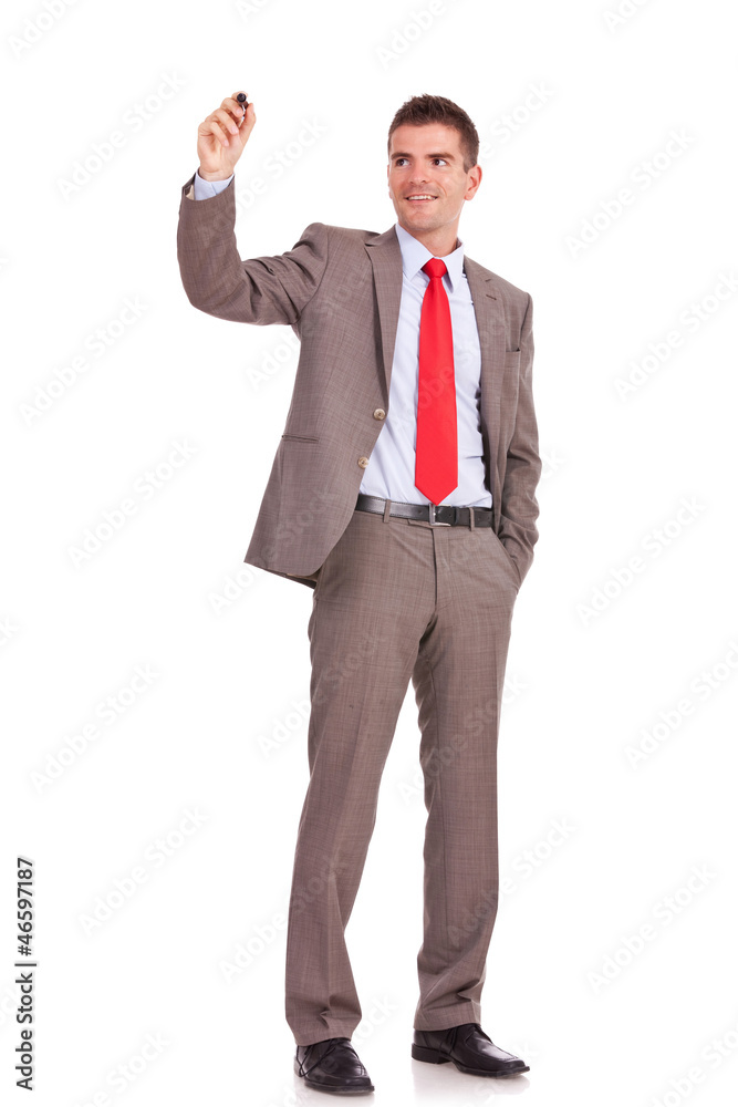 business man writing with a hand in pocket business man writing with a hand in pocket
