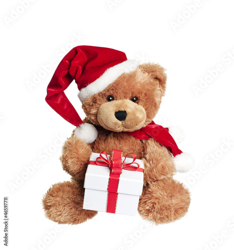 Obraz na plátně Cute toy bear with christmas gift on white