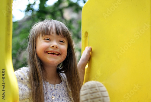 Portrait of beautiful young girl on the playground. photo