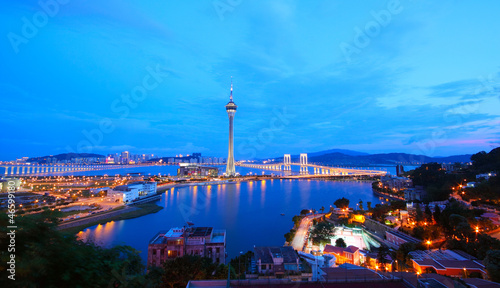 Cityscape in night with famous travel tower near river in Macao,