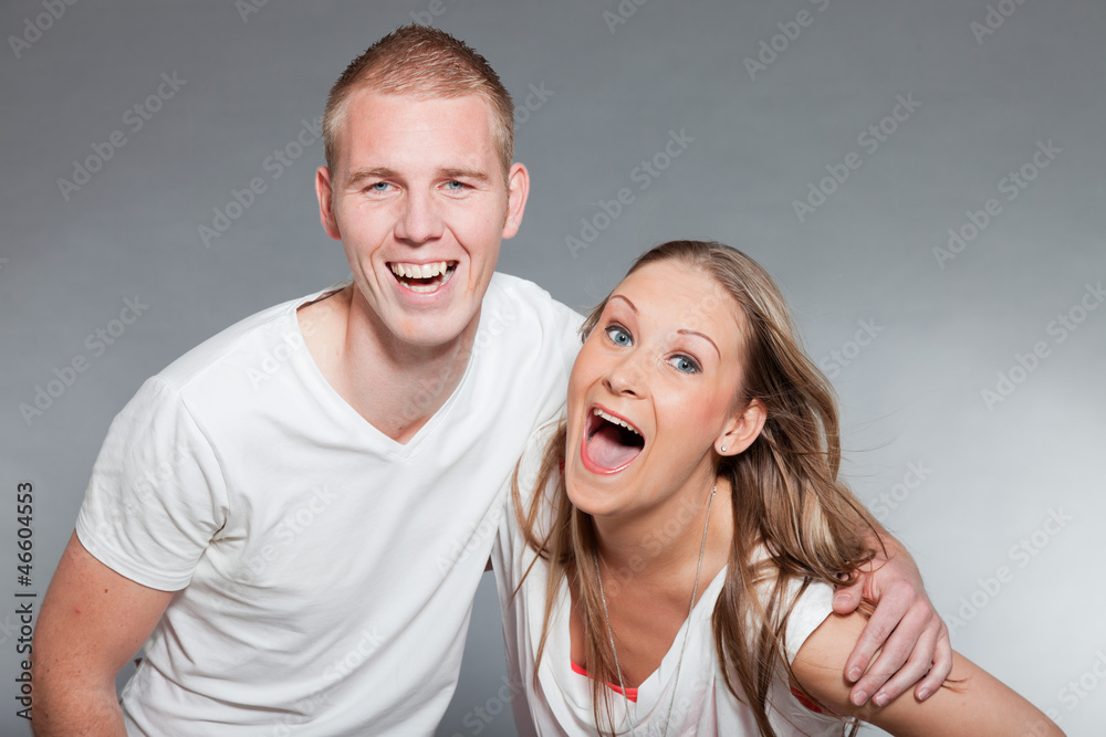Obraz premium Young couple together in love against grey wall. Studio shot.