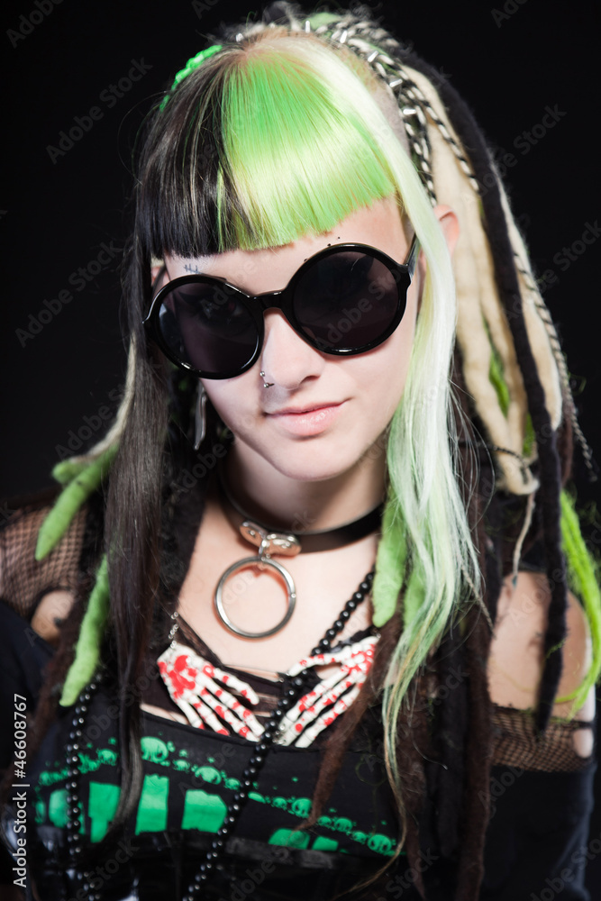 Cyber punk girl with green blond hair and red eyes against black Cyber punk girl with green blond hair and red eyes against black