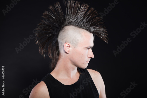 Obraz na plátně Punk man with mohawk haircut. Expressive face. Against black.