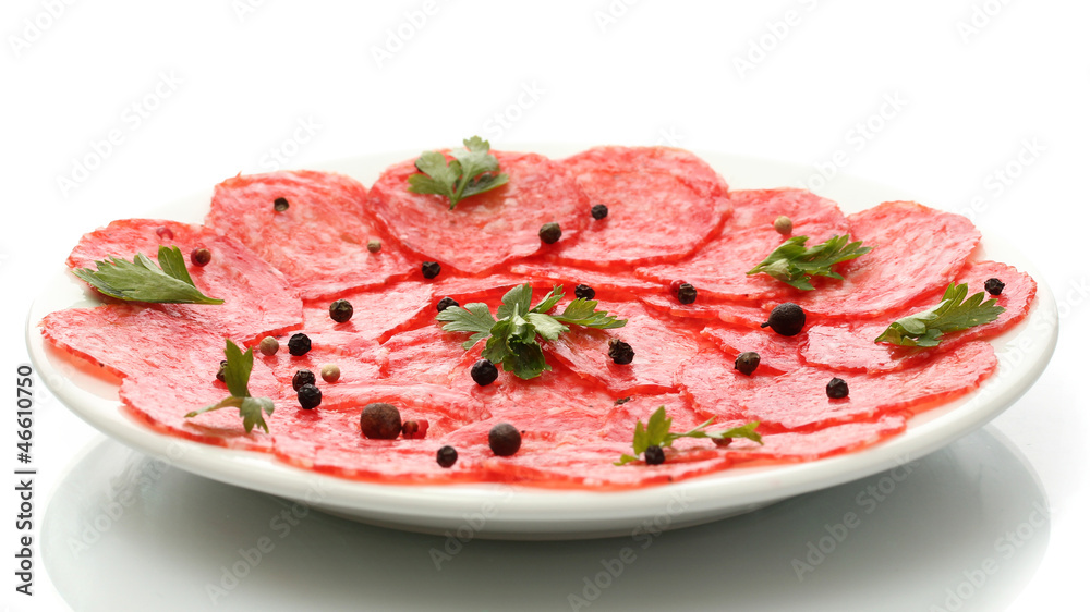 tasty sausage with spices on plate, isolated on white