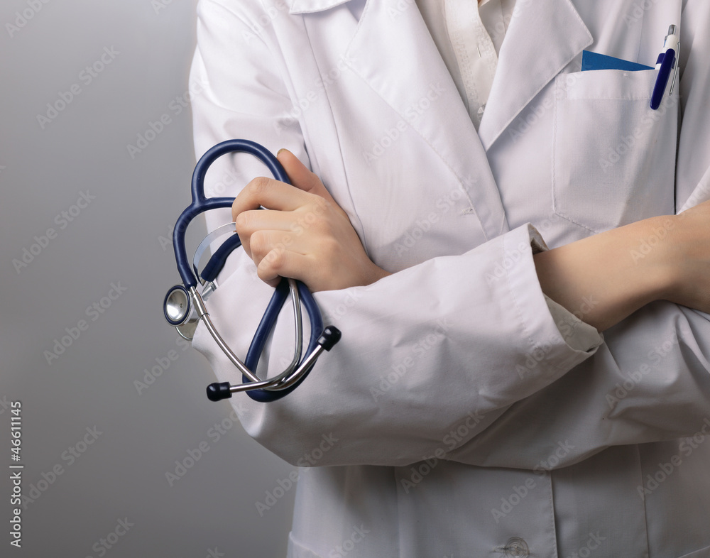 Closeup of female doctor's hand holding stethoscope Closeup of female doctor's hand holding stethoscope