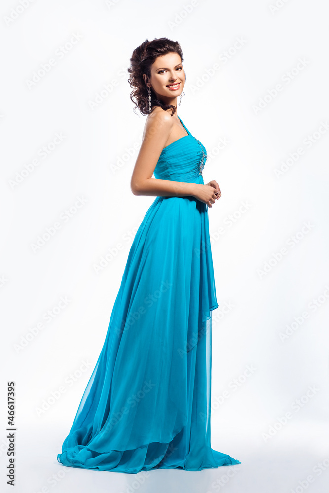 Feminine. Gorgeous graceful smiling brunette girl in blue dress Feminine. Gorgeous graceful smiling brunette girl in blue dress
