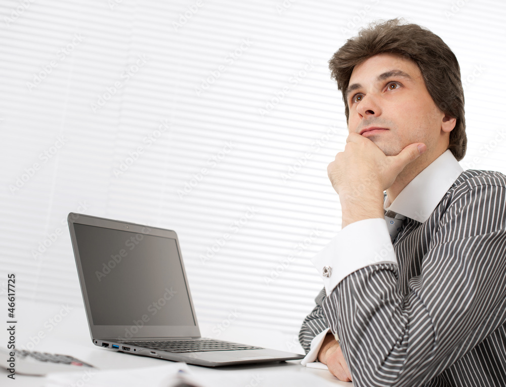 young business man thinking while working on laptop young business man thinking while working on laptop