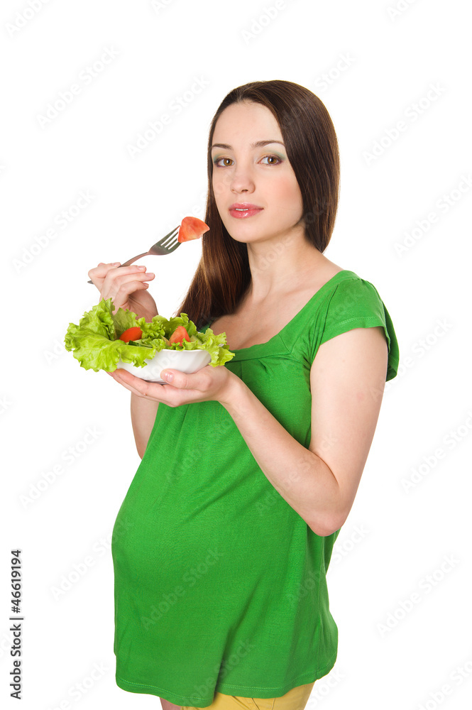 pregnant girl eats salad. isolated on white pregnant girl eats salad. isolated on white
