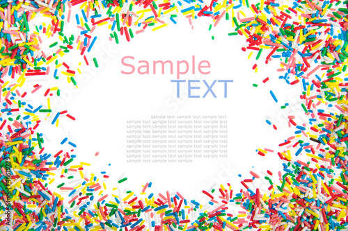 Frame made of little colorful sprinkles candy isolated on white