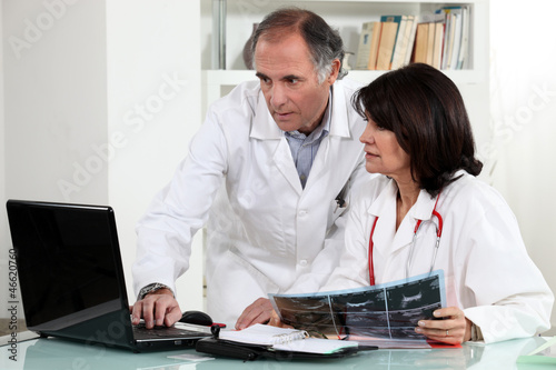 Two doctors examining x-ray