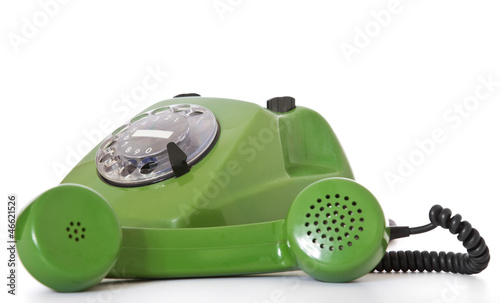 Altes grünes Telefon mit Telefonhörer daneben liegend photo