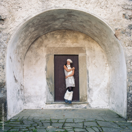 Young woman portrait with ancient building as background.