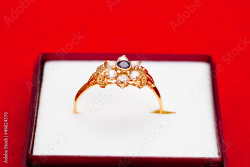 Gold ring with white and blue zirconia enchased photo