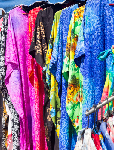 Clothing and fabrics in street market stall © steheap