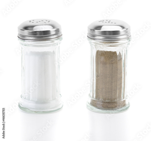 Glass salt and pepper shakers on white background