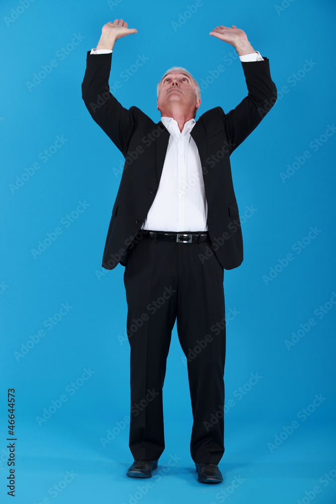 Senior businessman pushing upwards Senior businessman pushing upwards