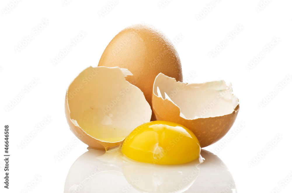 Broken egg close up on the white background Broken egg close up on the white background