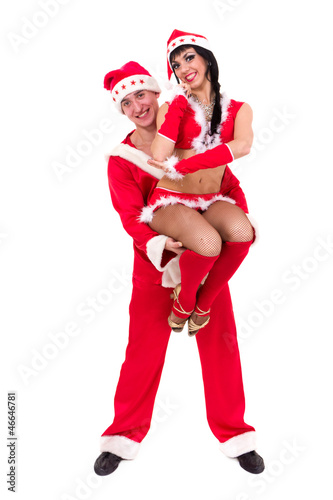 Happy young couple wearing santa claus clothes