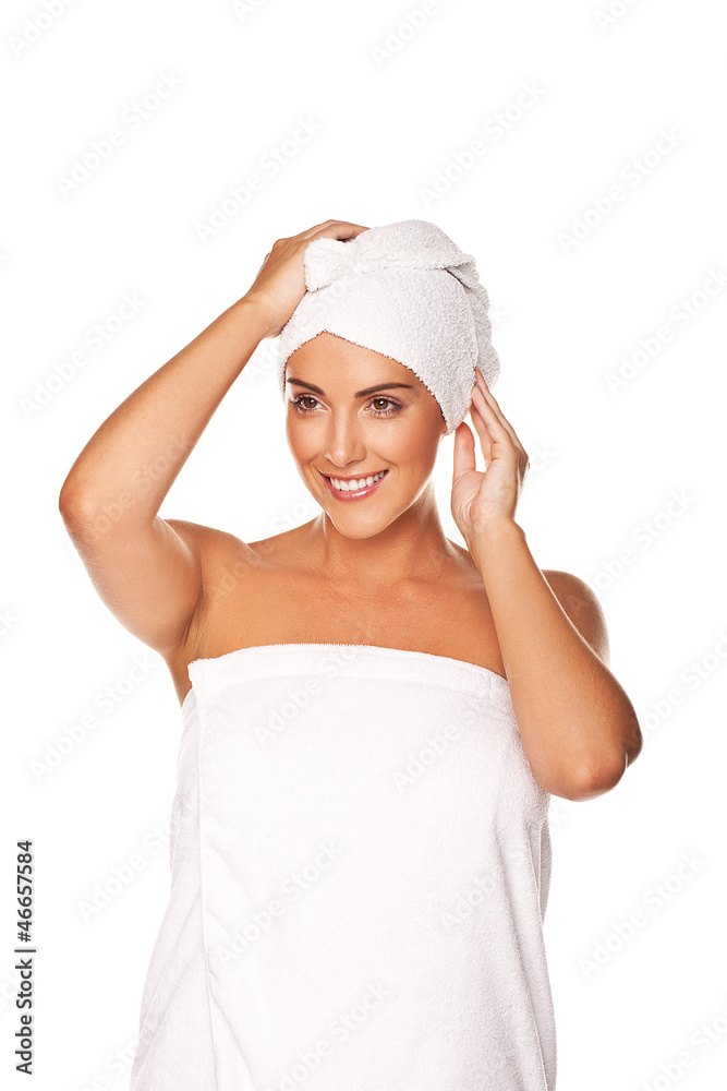 Beautiful woman tying a towel round her head Beautiful woman tying a towel round her head