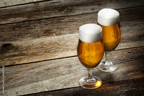Two glass beer on wood background with copyspace