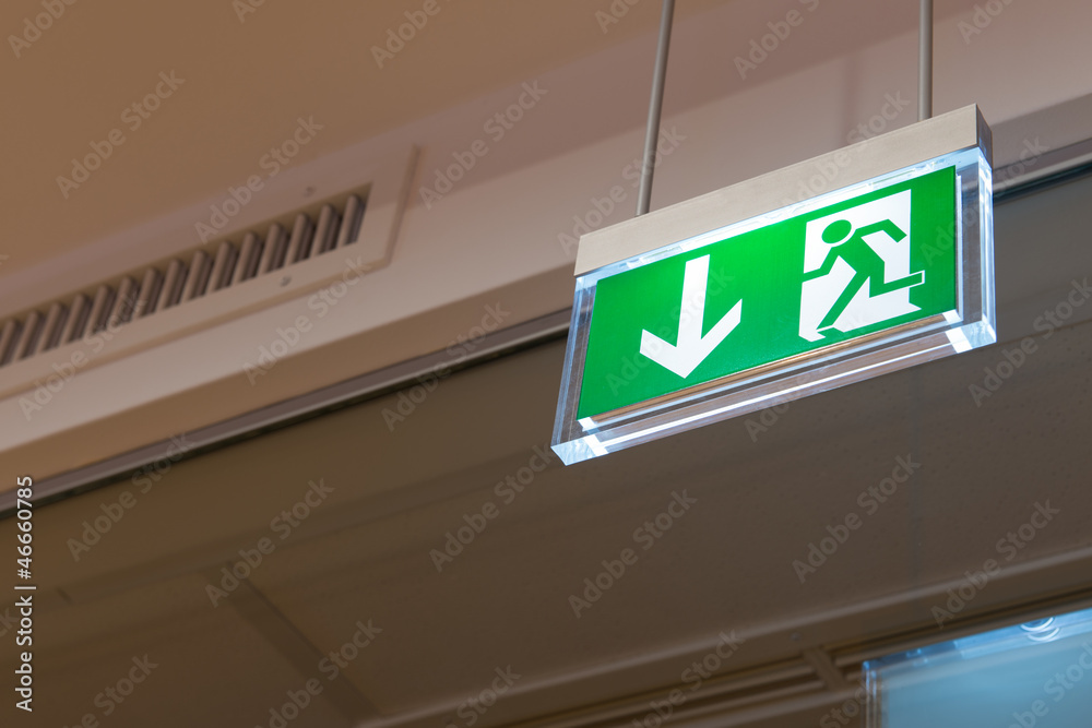 green illuminated exit sign on ceiling green illuminated exit sign on ceiling