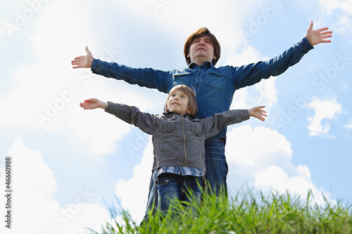 happy father with little son enjoying life over blue sky
