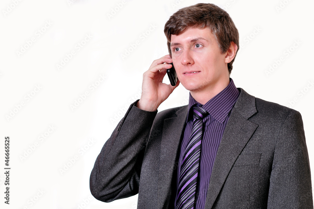 Young businessman in violet tie speaks by phone Young businessman in violet tie speaks by phone