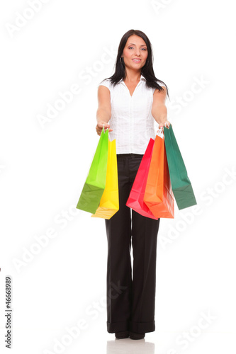 Full body portrait cheerful businesswoman holding shopping bags