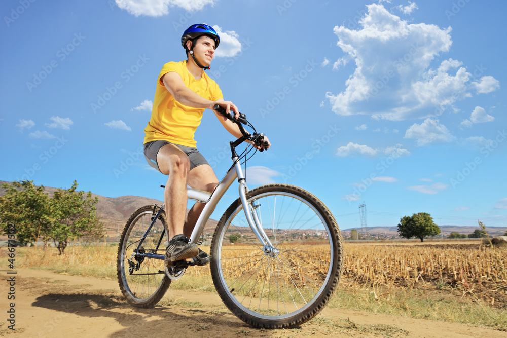 A young biker riding a mountain bike on a sunny day