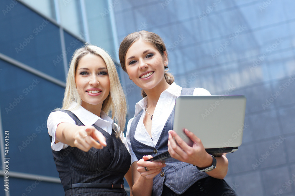 Two young and smart business women in formal clothes Two young and smart business women in formal clothes