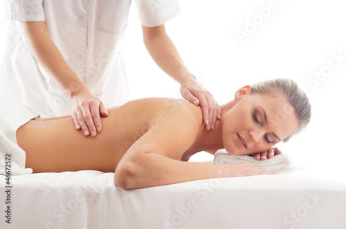 A young woman laying on a spa massage procedure