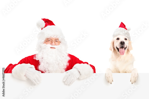 Santa Claus and dog posing behind a billboard