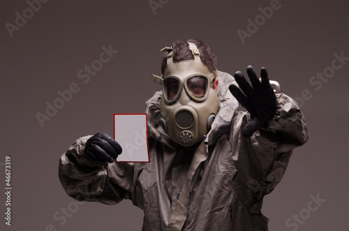 Man with a gas mask wearing hazmat suit, holding