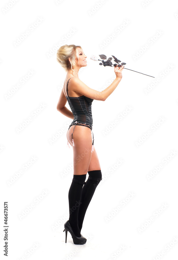 A young blond woman in black lingerie holding a flower A young blond woman in black lingerie holding a flower