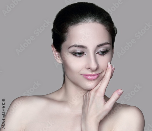 Beautiful woman with healthy skin touching hand face isolated on