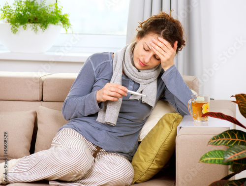 Sick Woman with Thermometer. Headache. Flu photo