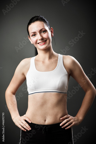 Beautiful sporty woman standing with hands on hips