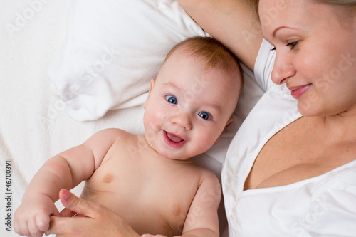 happy mother lying with bab...