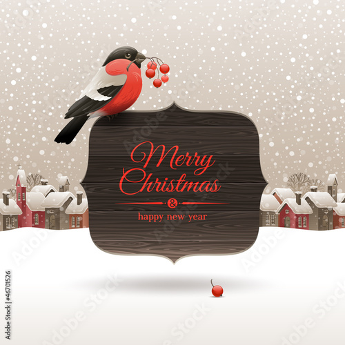 Bullfinch with ashberries on signboard with Christmas greeting